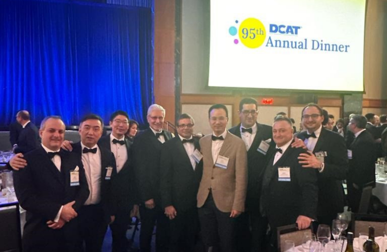 A group of men in tuxedos posing for a picture.