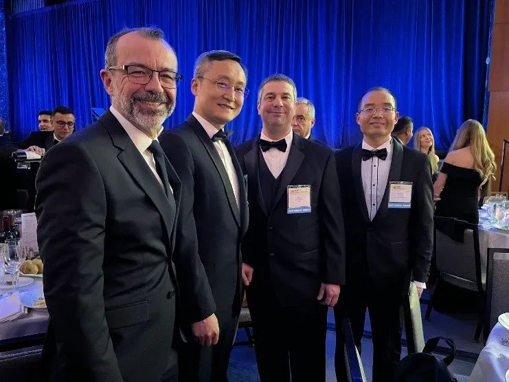 A group of men in tuxedos posing for a photo.
